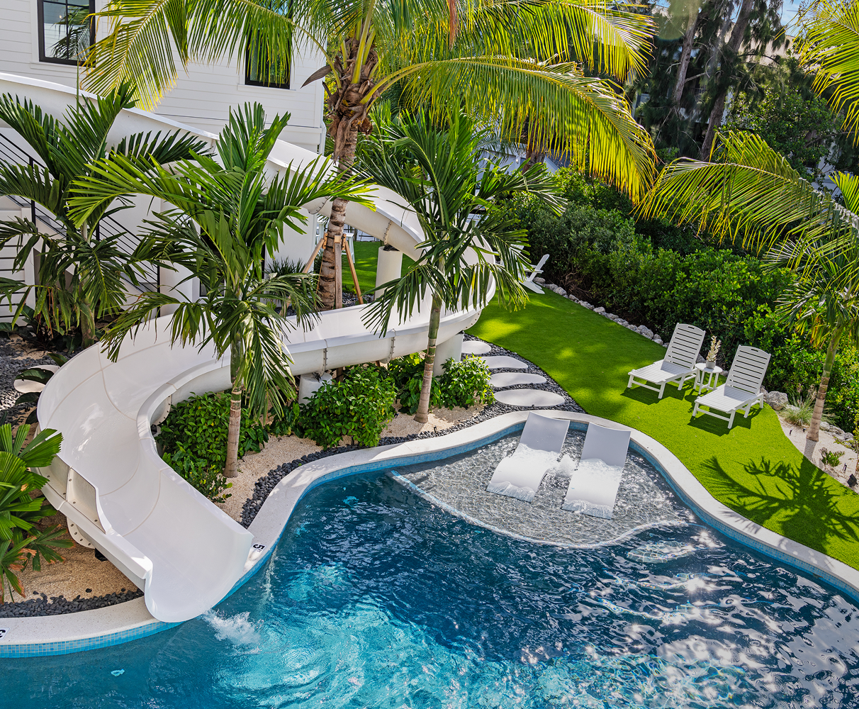 Custom water slide integrated into pool landscape